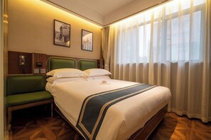 A hotel room with a large bed, a green bench, a wooden headboard, and a window with sheer curtains. - Nostalgia Hotel (Shanghai)
