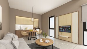 Un soggiorno moderno con divano, tavolino da caffè e zona pranzo con sedie, con una cucina sullo sfondo.