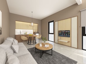 A modern living room with a sofa, a coffee table, and a dining area with chairs and a kitchen in the background.