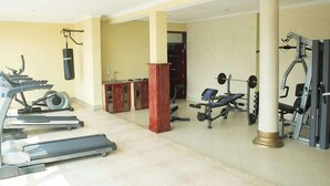 A gym with treadmills, a punching bag, and weightlifting equipment. - Martha Hotel Bujumbura (Bujumbura)