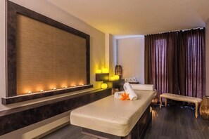 A modern spa room with a massage table, ambient lighting, and a large wall-mounted screen. - Best Boutique Hotel (Stara Zagora)