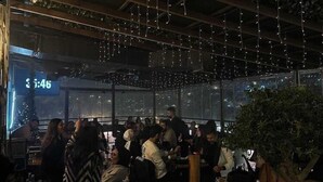 A crowded indoor space with hanging lights, tables, and chairs. - The Amman Pasha Hotel (Amman)