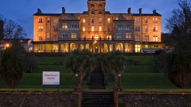 A large, historic hotel with a grand entrance, multiple floors, and a well-maintained garden. - Glenburn Hotel (Rothesay)