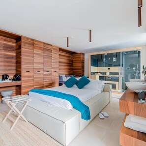 A modern bedroom with a large bed, wooden wardrobe, and a bathroom with a glass shower. - Cumeja Beach Club Hotel (Cellole)