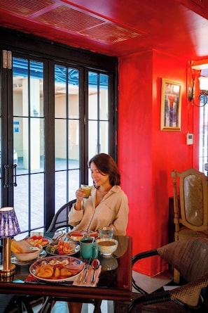 A dining area with a table set for two, featuring a variety of dishes and a coffee cup. - Quba by Montraj Pattaya (Pattaya)