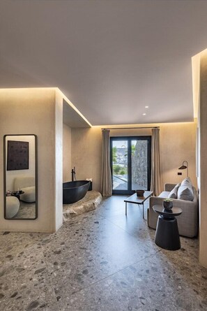 A modern bathroom with a bathtub, a mirror, and a window with curtains. - Aeonic Suites and Spa - Adults Only (Mykonos)