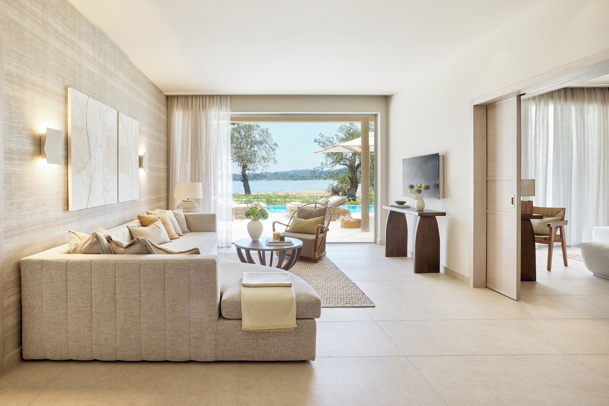 A modern living room with a sofa, a coffee table, and a TV.