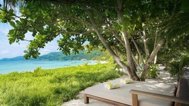A beachside lounge with a view of the ocean and a mountain in the background. - Laila, Seychelles, a Tribute Portfolio Resort (Mahé Island)
