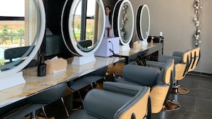 A salon with multiple mirrors, a reception desk, and a sign indicating it is a Waves Beauty & Medical Spa. - Waves Aquaparc (Kenitra)