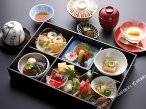 A traditional Japanese meal with various dishes arranged on a tray. - Hotel Urban (Tokyo)