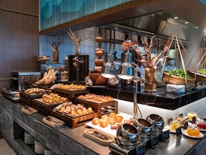 A buffet with various food items and decorative elements. - Crowne Plaza Danang City Centre by IHG (Da Nang)