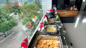 A buffet with various dishes, including a large container of mixed vegetables and a tray of fried items. - Front One Green Boutique Hotel Abepura (Jayapura)