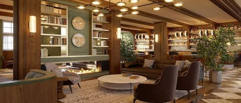 A spacious lobby with a fireplace, seating area, and a well-stocked library.