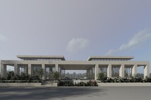 Un bâtiment moderne doté d’un toit plat, de grandes fenêtres et d’une entrée centrale.