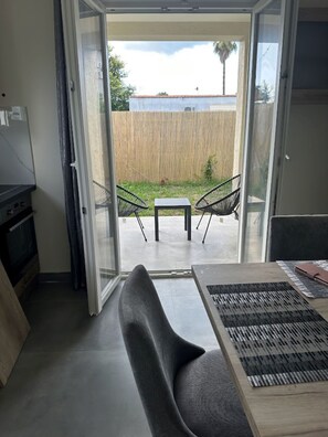 A room with a sliding glass door leading to an outdoor patio area. - Aqua Luxury Suites (Corfu)