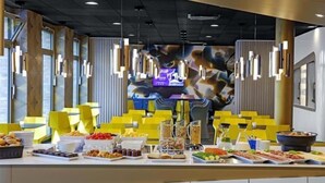 A buffet setup with various food items and a modern interior design. - Prize by Radisson, Erfurt City (Erfurt)