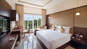 A modern hotel room with a large bed, a desk, a TV, and a view of the outdoors. - Accord Chrome Airport Hotel (Chennai)