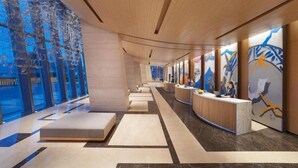 A modern hotel lobby with a reception desk, seating areas, and large windows. - Hyatt Regency Hengqin (Zhuhai)