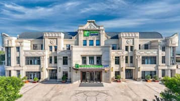 A large, classical building with a central entrance, multiple windows, and a prominent sign for 'Hotel Express.'