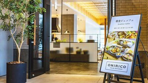 An Italian restaurant with a breakfast buffet, a reception desk, and a potted plant. - La Gent Stay Shin Sapporo (Sapporo)