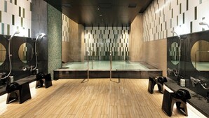 A modern bathroom with a central shower area, multiple sinks, and mirrors. - La Gent Stay Shin Sapporo (Sapporo)
