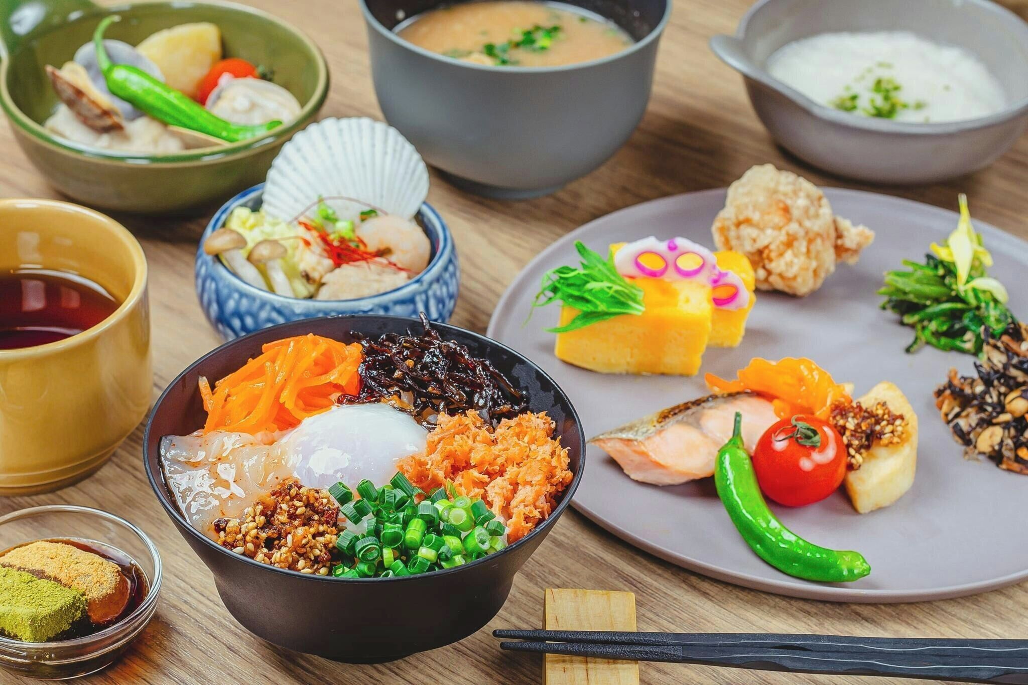 A variety of Japanese dishes on a wooden table.