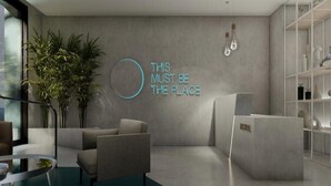 A modern lobby with a reception desk, seating area, and a large plant. - Hotel Mistral St. Julian's (St. Julian's)