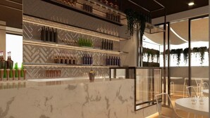 A modern bar area with marble countertops, shelves of bottles, and hanging plants. - Hotel Mistral St. Julian's (St. Julian's)