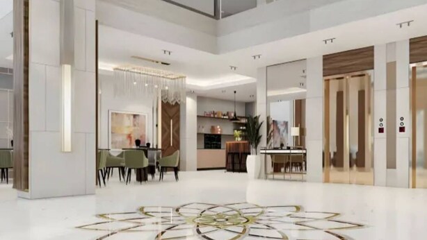 A spacious hotel lobby with a modern design, featuring a central seating area, a decorative floor pattern, and a large chandelier. - Dream Residence Olaya Khobar (Al Khobar)