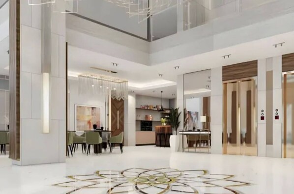 A spacious hotel lobby with a modern design, featuring a central seating area, a decorative floor pattern, and a large chandelier. - Dream Residence Olaya Khobar (Al Khobar)