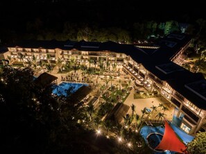 A resort with multiple buildings, a central pool, and surrounding palm trees. - Ocean's Creek (Balaclava)