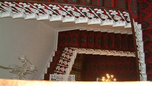 A staircase with ornate railings and patterned carpet. - Terrace Hotel (Edinburgh)