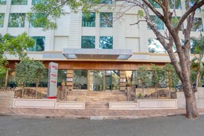 A modern building with a wooden facade, large windows, and a signboard. - 7 Apple Hotel Vimannagar, Pune (Pune)