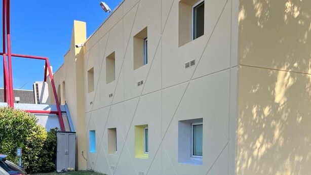 A building with a modern design, featuring multiple small windows and a flat facade. - Hotel Classeco Gent (Ghent)