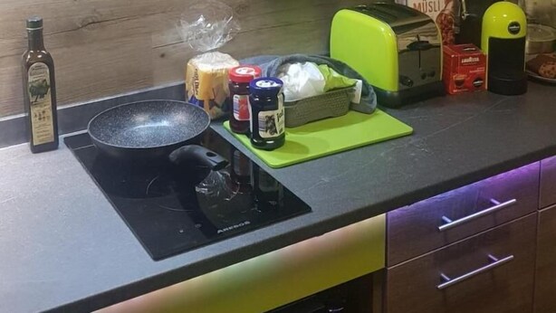 A kitchen with a gas stove, a toaster, and various food items on the counter. - Modern Hoteliving Giessen (Pohlheim)