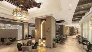 A spacious hotel lobby with a central reception desk, seating areas, and a decorative ceiling. - Gewan Resort New Alamein (El Alamein)