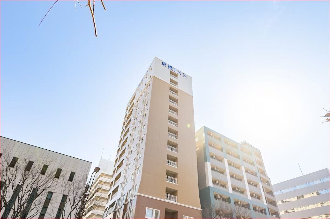 A multi-story hotel building with a prominent sign at the top.