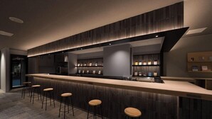 A modern bar area with a long counter and multiple stools. - Book Hotel Kyotokujo (Otsu)