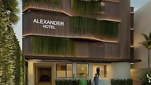 A modern hotel with a prominent sign reading 'ALEXANDER HOTEL.' - Alexander Hotel Tegal (Tegal)