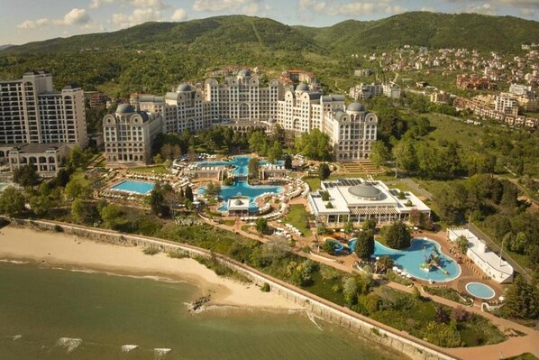 A large resort with multiple buildings, a central pool area, and a beach. - Alua Sunny Beach Resort & Spa (Nessebar)