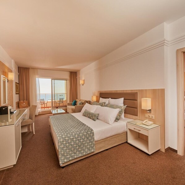 A hotel room with a bed, desk, chair, and a balcony with a view. - Alua Sunny Beach Resort & Spa (Nessebar)