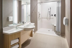 A modern bathroom with two sinks, a shower, and a toilet. - Springhill Suites Franklin Mint (South Portland)