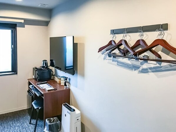 A hotel room with a desk, a flat-screen TV, a coffee maker, a trash bin, and a wall-mounted coat rack. - Hotel Live Max Nagoya Sakuradoriguchi (Nagoya)