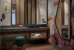 A modern bathroom with a granite countertop, a blue basin, a wooden vanity, a mirror, and a towel rack. - Canopy by Hilton Seychelles (Mahé Island)