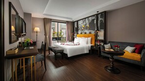 A hotel room with a bed, a sofa, a desk, and a chair. - Ha Noi Lion Boutique Hotel (Hanoi)
