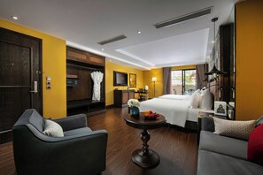A hotel room with a bed, a sofa, a dining table, a TV, a wardrobe, and a bathroom. - Ha Noi Lion Boutique Hotel (Hanoi)