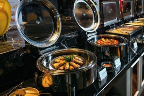 A buffet with various food options, including a bowl of spring rolls and a bowl of mixed vegetables. - Ha Noi Lion Boutique Hotel (Hanoi)