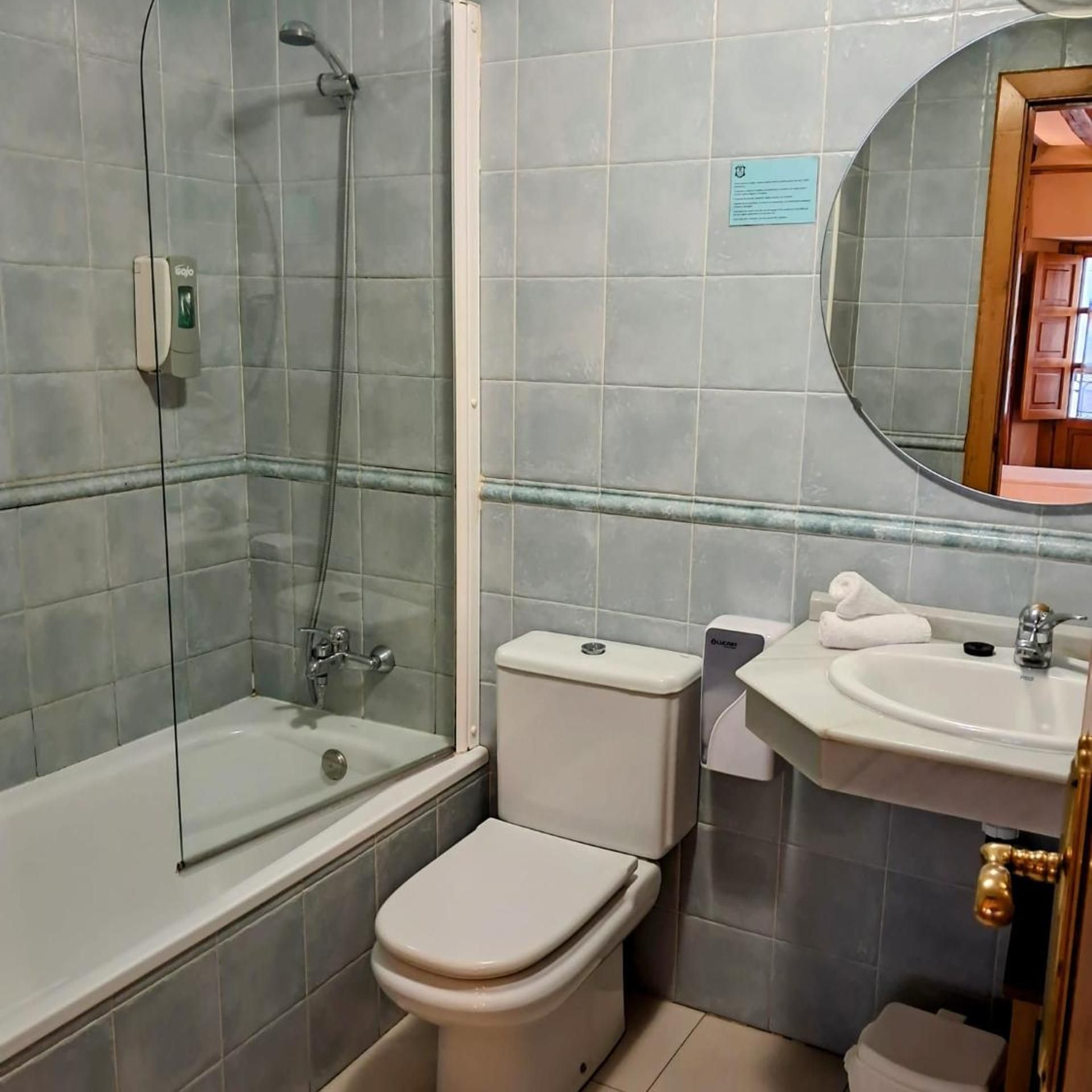 A bathroom with a bathtub, toilet, and sink.