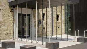 A stone building with a covered entrance and a sign reading "The Bourne Hall Hotel". - The Bodmin Jail Hotel (Bodmin)