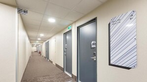 A hotel hallway with doors numbered 103, 104, and 105. - B&B Hotel Le Port Marly Saint Germain en Laye (La Haute-Maison)